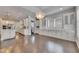Open concept kitchen and dining room with white cabinets, stainless appliances, and hardwood floors at 5316 Candler View Dr, Lithia, FL 33547