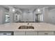 Bright open kitchen with quartz countertop, stainless steel appliances, island sink, and modern pendants at 5316 Candler View Dr, Lithia, FL 33547