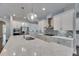 Spacious kitchen with white cabinets, quartz countertops, modern appliances and unique backsplash design at 5316 Candler View Dr, Lithia, FL 33547