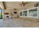 This covered lanai features an outdoor kitchen with stainless steel BBQ and refrigerator plus a mounted TV at 5316 Candler View Dr, Lithia, FL 33547