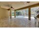 This screened-in lanai has travertine tile floors, a granite counter outdoor kitchen and a view of the lovely pool area at 5316 Candler View Dr, Lithia, FL 33547