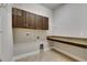 Laundry room with dark cabinets, granite countertop, and ample space for appliances at 5316 Candler View Dr, Lithia, FL 33547
