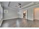 Primary bedroom with trey ceilings, wood-look flooring, and ensuite bathroom at 5316 Candler View Dr, Lithia, FL 33547