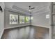 Main bedroom featuring tray ceilings, a ceiling fan, and lots of natural light at 5316 Candler View Dr, Lithia, FL 33547