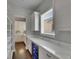 Walk-in pantry with custom shelving, quartz countertops, wine cooler and view to the modern kitchen at 5316 Candler View Dr, Lithia, FL 33547