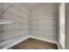 Spacious walk-in closet featuring hardwood floors and built-in wire shelving at 5316 Candler View Dr, Lithia, FL 33547