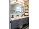 Bathroom boasts dual sinks, a large framed mirror, and modern fixtures at 600 Eleuthera Dr, Punta Gorda, FL 33950