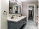 Stylish bathroom featuring double vanity, modern fixtures, and walk in closets at 600 Eleuthera Dr, Punta Gorda, FL 33950