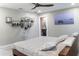 Bright bedroom with floating shelves, ceiling fan, neutral walls, and a comfortable bed at 600 Eleuthera Dr, Punta Gorda, FL 33950