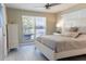 Cozy bedroom features a large window, neutral tones, and a ceiling fan at 600 Eleuthera Dr, Punta Gorda, FL 33950