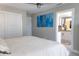 Spacious bedroom with light-colored walls, access to the kitchen, and a comfortable bed at 600 Eleuthera Dr, Punta Gorda, FL 33950