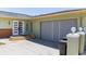 Inviting home exterior with a modern front door, gray garage door, and landscaped yard at 600 Eleuthera Dr, Punta Gorda, FL 33950