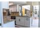 A bright kitchen features granite counters, white cabinets, stainless steel appliances, and modern black hardware at 600 Eleuthera Dr, Punta Gorda, FL 33950