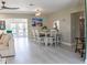 Open living space features modern furnishings, light-colored flooring, dining area, and access to outdoor space at 600 Eleuthera Dr, Punta Gorda, FL 33950