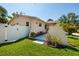 Fenced backyard and covered patio with tropical landscaping and a lush green lawn at 6001 19Th Ne St, St Petersburg, FL 33703
