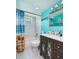 Bathroom featuring a vanity with a mirror, toilet, shower with blue shower curtain, and blue walls at 6001 19Th Ne St, St Petersburg, FL 33703