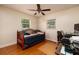 Bedroom featuring a daybed with a wooden frame, ceiling fan, and natural light from two windows at 6001 19Th Ne St, St Petersburg, FL 33703