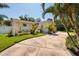 Single-story home boasts a curved driveway, lush landscaping, and a neutral-toned exterior at 6001 19Th Ne St, St Petersburg, FL 33703