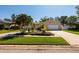 Beautiful single-Gathering home with green lawn, mature palms, and well-maintained landscaping at 6001 19Th Ne St, St Petersburg, FL 33703