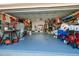View of the spacious garage with a blue painted floor, washer and dryer, and storage cabinets at 6001 19Th Ne St, St Petersburg, FL 33703