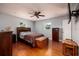 Comfortable bedroom with hardwood floors, ceiling fan, dresser and natural light at 6001 19Th Ne St, St Petersburg, FL 33703