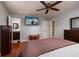 Bedroom featuring hardwood floors, ceiling fan, ensuite bathroom and natural light at 6001 19Th Ne St, St Petersburg, FL 33703