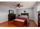 Inviting bedroom with hardwood floors, ceiling fan, dresser, and a serene ambiance at 6001 19Th Ne St, St Petersburg, FL 33703