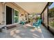 Enclosed patio featuring blue outdoor furniture, fan and sliding glass door to enter inside at 6001 19Th Ne St, St Petersburg, FL 33703