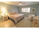 Cozy bedroom with neutral décor, a ceiling fan, and a window letting in natural light at 6060 Shore S Blvd # 302, Gulfport, FL 33707
