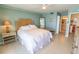 Relaxing bedroom featuring tile flooring, a ceiling fan, and a glimpse into the ensuite bathroom at 6060 Shore S Blvd # 302, Gulfport, FL 33707