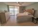 Inviting bedroom with a ceiling fan, tile floors, and a balcony overlooking the ocean at 6060 Shore S Blvd # 302, Gulfport, FL 33707