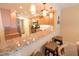 Kitchen featuring granite countertops, stainless steel appliances, and a breakfast bar with three chairs at 6060 Shore S Blvd # 302, Gulfport, FL 33707