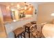 Well-lit kitchen featuring a breakfast bar with granite countertops and stylish pendant lighting at 6060 Shore S Blvd # 302, Gulfport, FL 33707