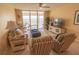 Bright living room with a ceiling fan and sliding glass doors opening to a balcony with water views at 6060 Shore S Blvd # 302, Gulfport, FL 33707