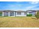 A well-kept backyard featuring a covered patio and lush greenery, perfect for entertaining and relaxation at 6398 Bradford Woods Drive, Zephyrhills, FL 33542