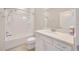 This well-lit bathroom features a shower and a single sink vanity at 6398 Bradford Woods Drive, Zephyrhills, FL 33542