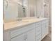 This bathroom features a dual sink vanity with a light countertop and white cabinets at 6398 Bradford Woods Drive, Zephyrhills, FL 33542