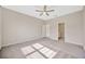 This spacious bedroom features a ceiling fan, neutral paint and plenty of natural light at 6398 Bradford Woods Drive, Zephyrhills, FL 33542