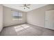 This bedroom features a window, a ceiling fan, and neutral paint to match your decor at 6398 Bradford Woods Drive, Zephyrhills, FL 33542