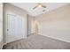 This spacious bedroom features a ceiling fan, closet, and neutral paint to match your decor at 6398 Bradford Woods Drive, Zephyrhills, FL 33542