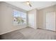 The bedroom offers carpeted floors and a large window at 6398 Bradford Woods Drive, Zephyrhills, FL 33542