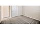 This bedroom features carpeted floors, a closet, and a door at 6398 Bradford Woods Drive, Zephyrhills, FL 33542