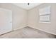 This cozy bedroom offers neutral paint colors and a bright window at 6398 Bradford Woods Drive, Zephyrhills, FL 33542