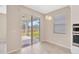 Dining area features a sliding glass door to the patio and a window for natural light, with views of the backyard at 6398 Bradford Woods Drive, Zephyrhills, FL 33542
