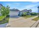 Charming single-story home with a two-car garage, well-manicured lawn, and inviting curb appeal at 6398 Bradford Woods Drive, Zephyrhills, FL 33542