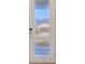 Modern front door with a vertical window panel and a smart lock offers both style and security at 6398 Bradford Woods Drive, Zephyrhills, FL 33542