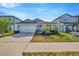Charming single Gathering home boasting lush landscaping, a paver driveway, and an attached two-car garage at 6398 Bradford Woods Drive, Zephyrhills, FL 33542