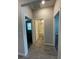 Hallway showcasing access to a bathroom and bedrooms with neutral paint and tile flooring at 6398 Bradford Woods Drive, Zephyrhills, FL 33542