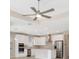 Open-concept kitchen with white cabinets, stainless steel appliances, and a center island with pendant lighting at 6398 Bradford Woods Drive, Zephyrhills, FL 33542