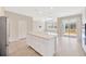 Open-concept kitchen featuring a large island with white cabinetry, stainless steel appliances, and ample counter space at 6398 Bradford Woods Drive, Zephyrhills, FL 33542